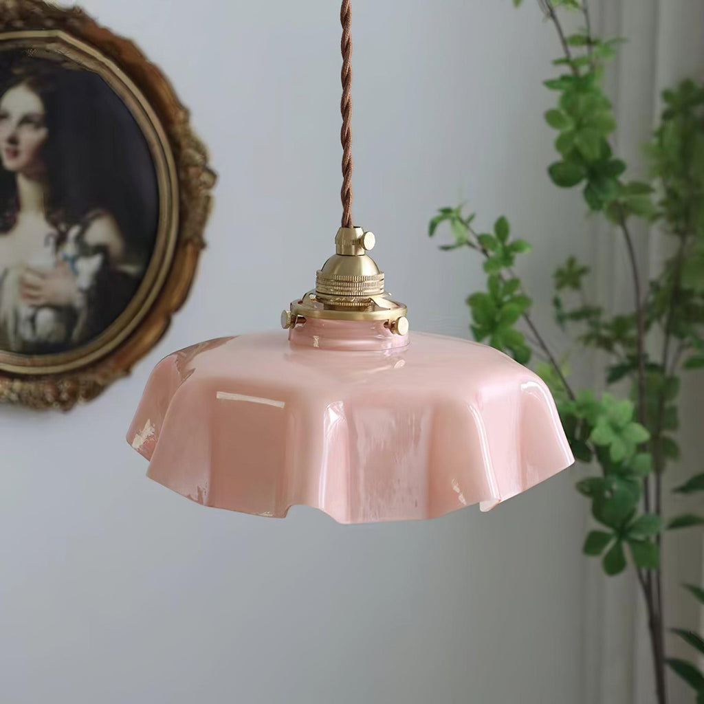 French pendant light with pleated glass shade over a table