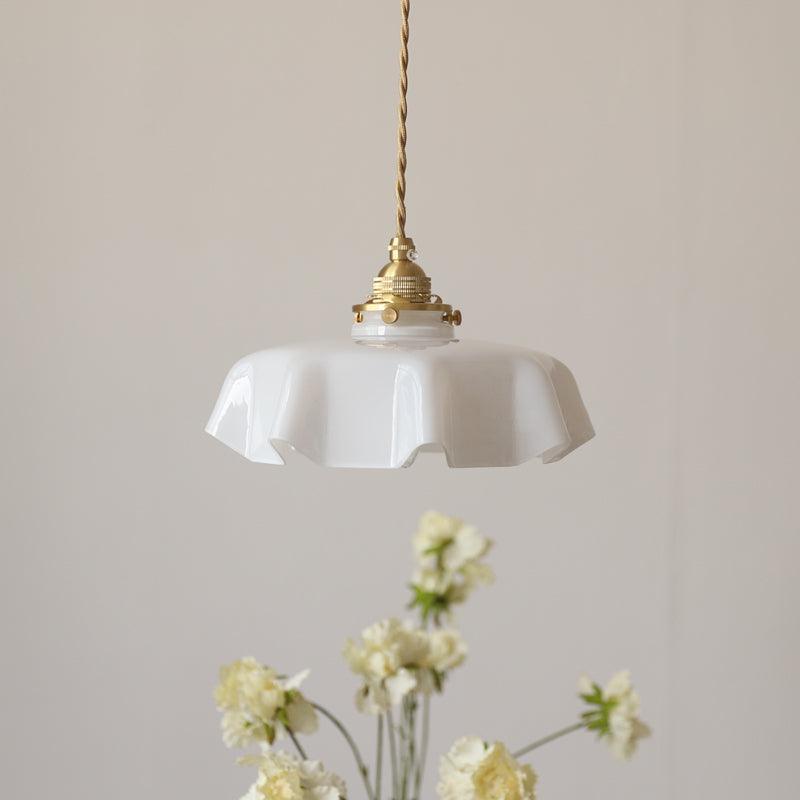 Pleated glass pendant light with soft toned shade and brass body