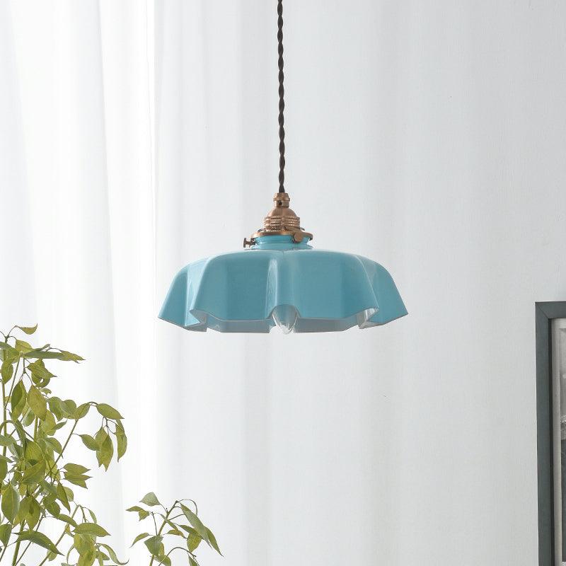 Pleated glass pendant light with soft shade casting warm light