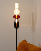 Hand-blown glass cluster floor lamp standing on a black post