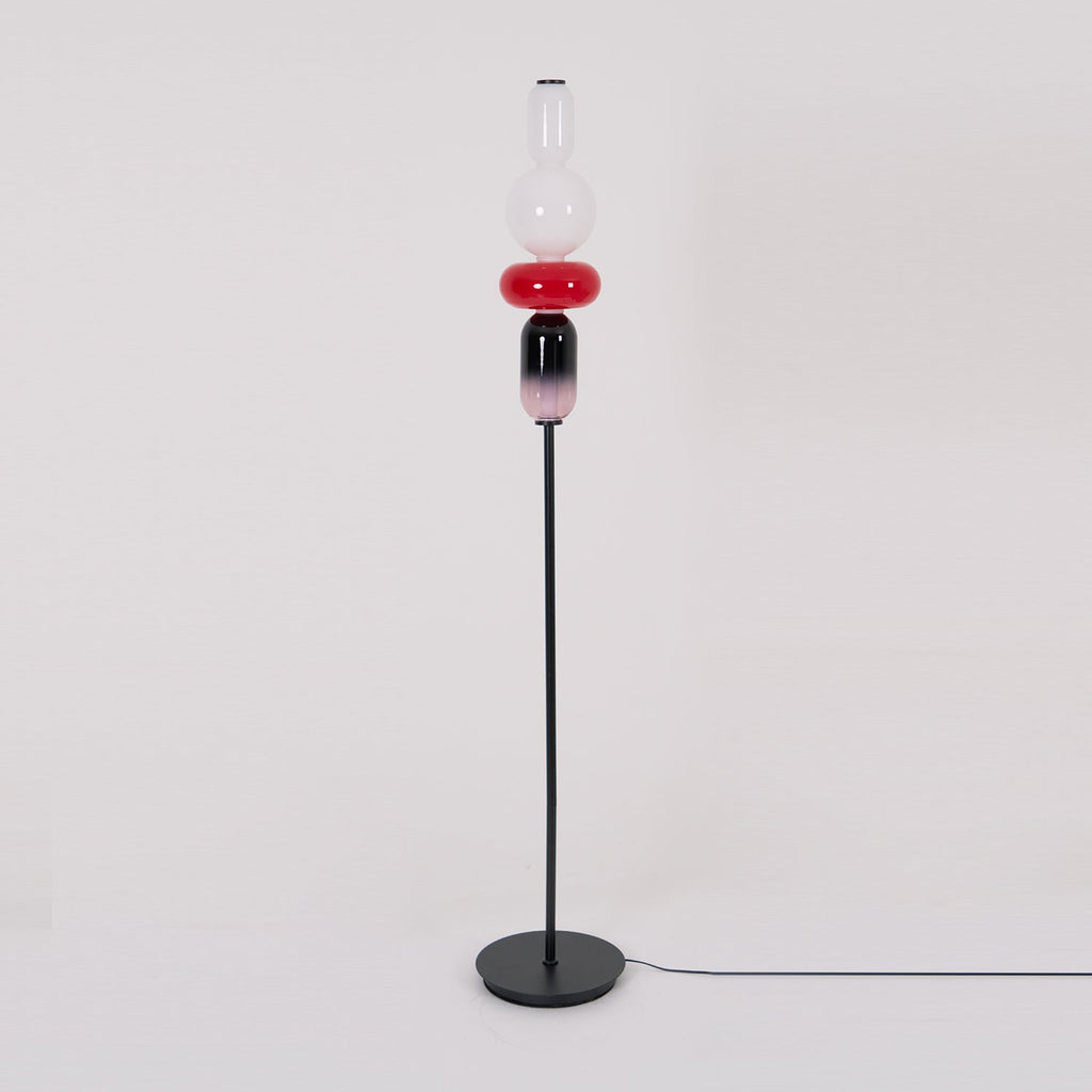 Hand-blown glass floor lamp components lit from within
