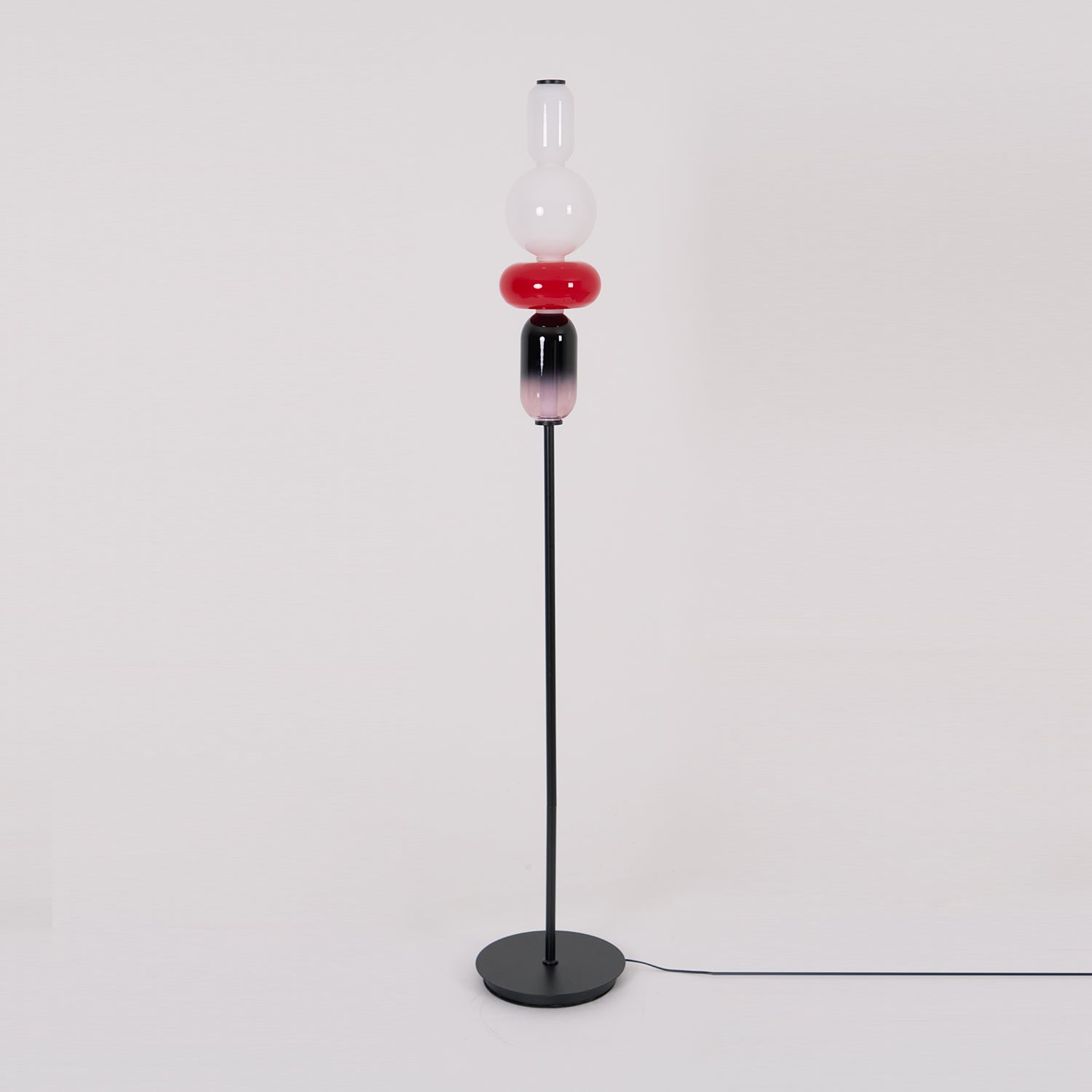 Hand-blown glass floor lamp components lit from within