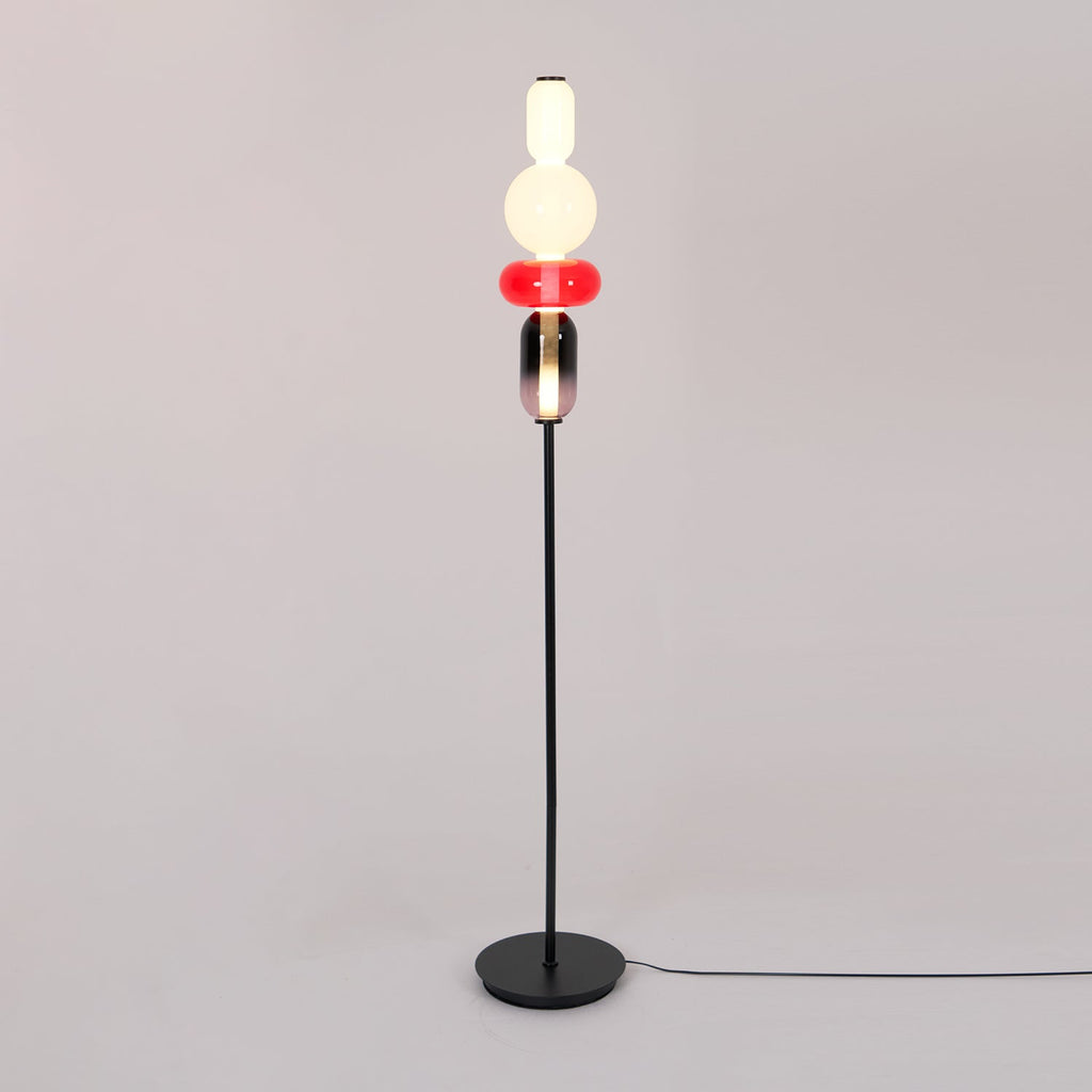 Detail of crystal glass clusters on a slim black floor lamp