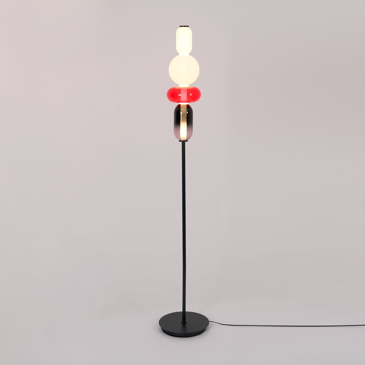 Detail of crystal glass clusters on a slim black floor lamp