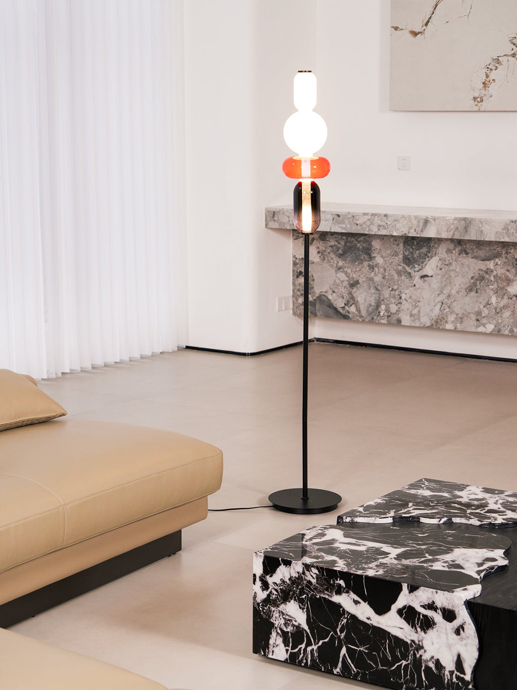 Close view of glowing hand-blown glass pebbles on a floor lamp