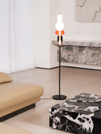Close view of glowing hand-blown glass pebbles on a floor lamp