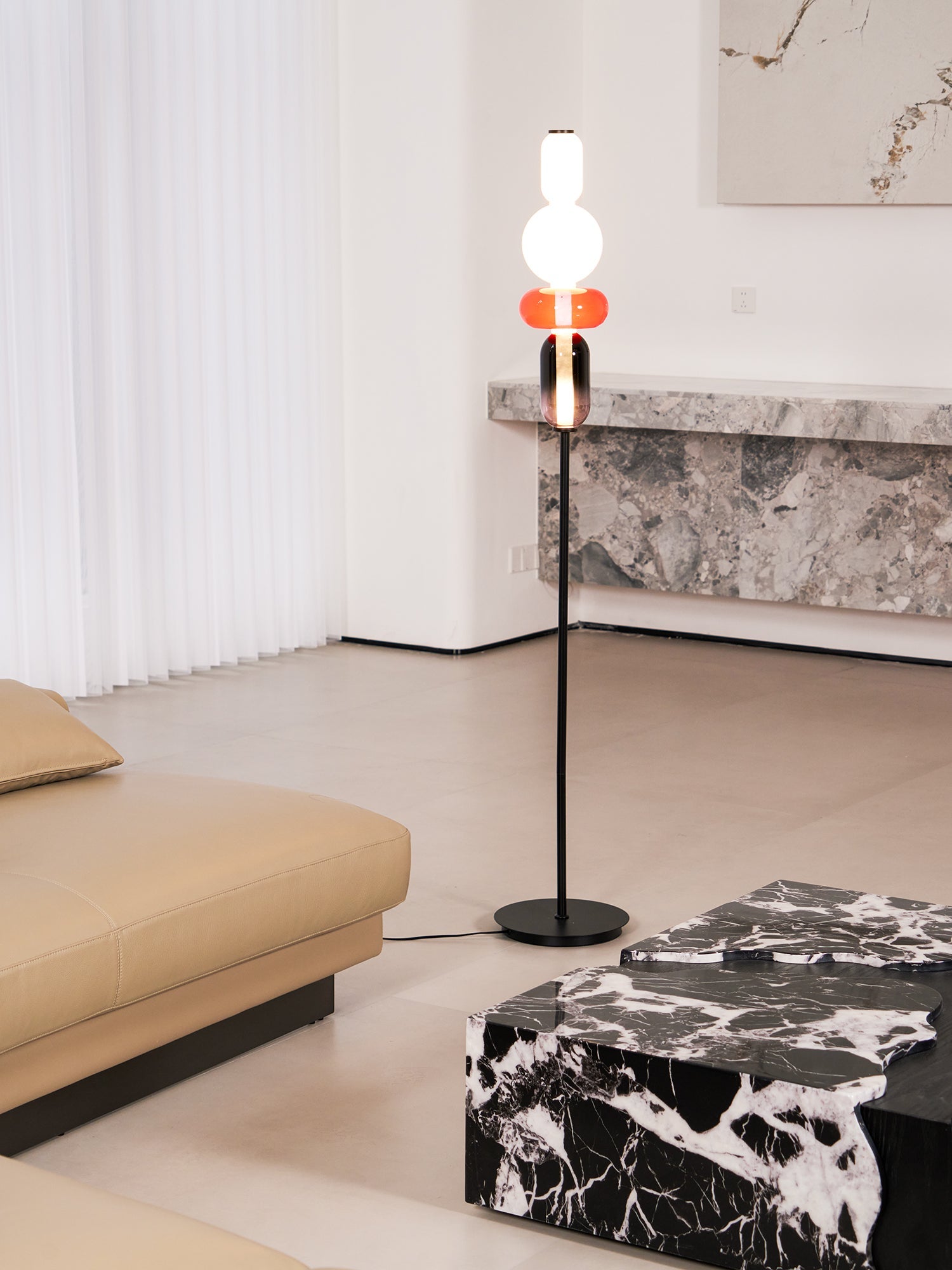 Close view of glowing hand-blown glass pebbles on a floor lamp