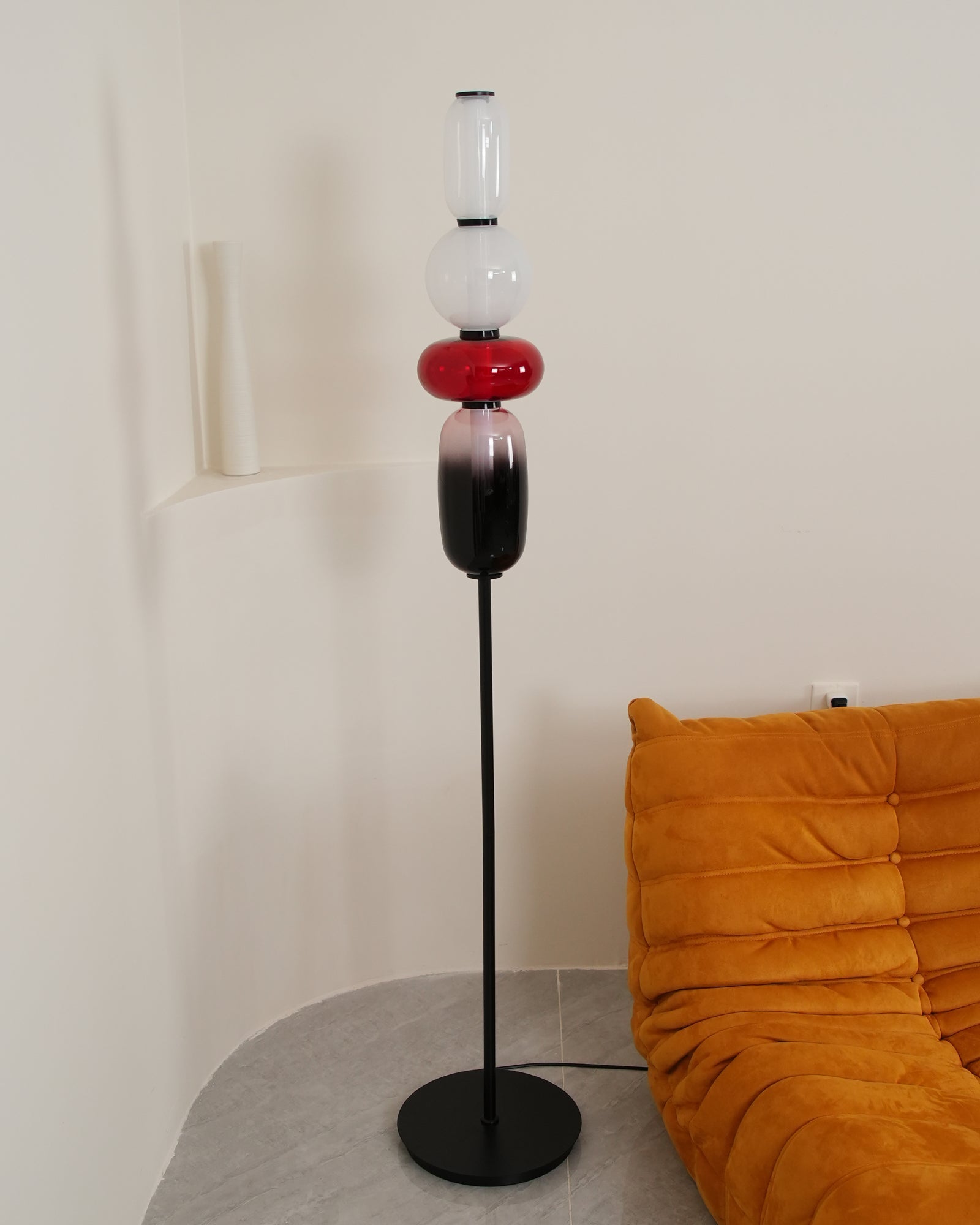 Crystal glass cluster floor lamp lit against a dark backdrop