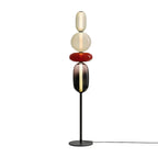 Crystal cluster floor lamp on a black post beside a sofa