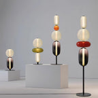 Hand-blown glass lamp glowing warmly against a neutral wall