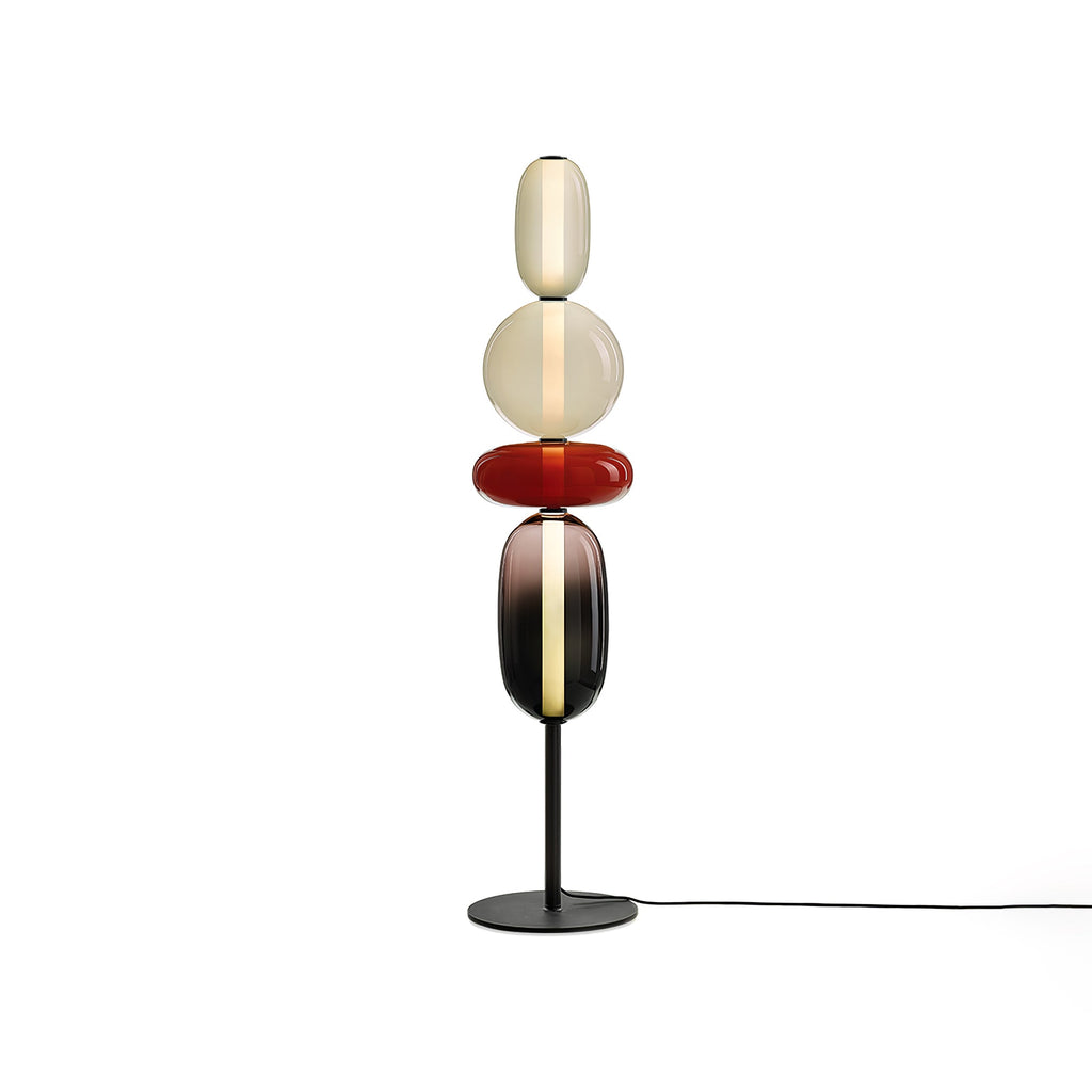Hand-blown glass cluster floor lamp glowing in a dim living room