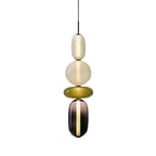 Tinted glass jar pendant light glowing in a styled room
