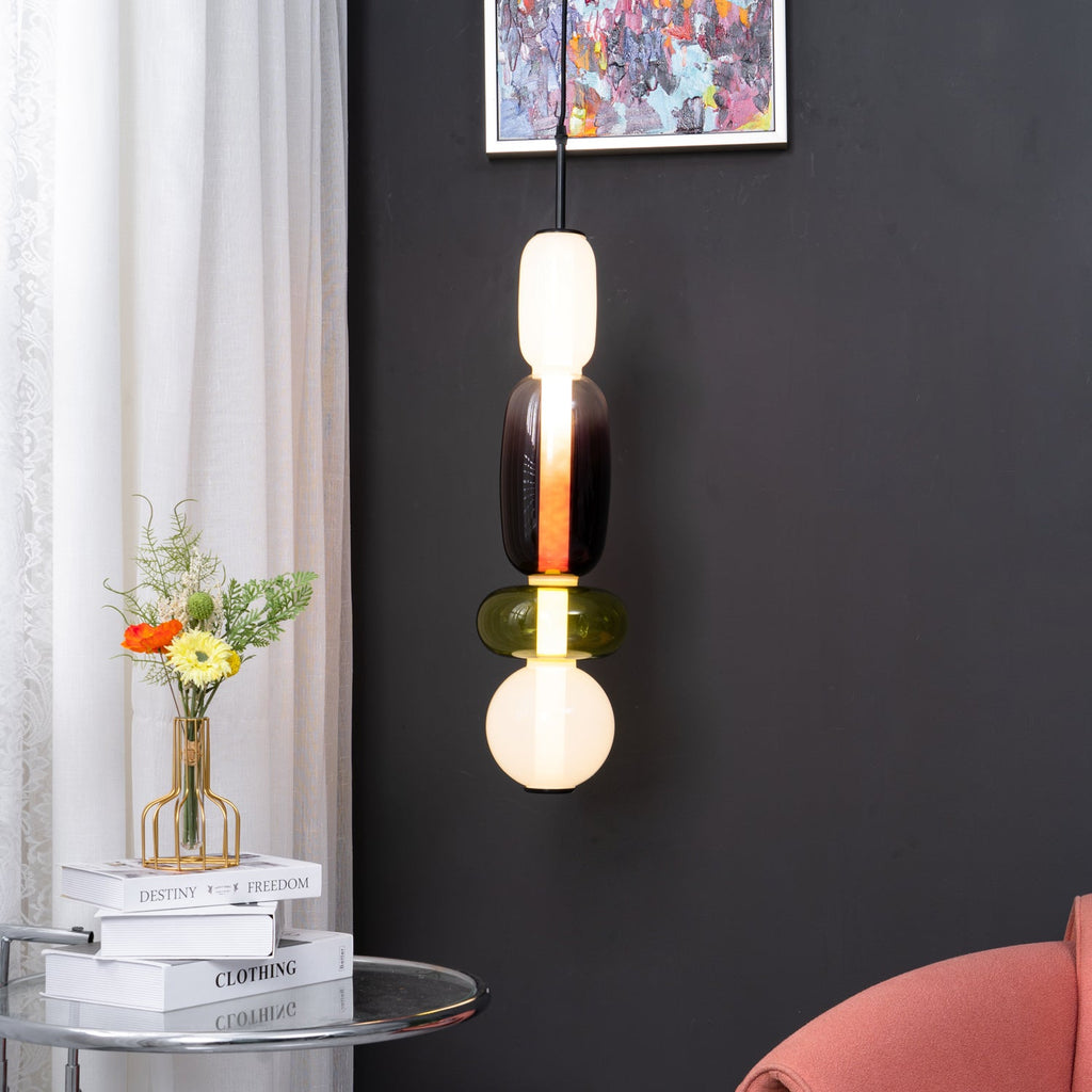 Glass jar pendant light lit warmly in an interior setting