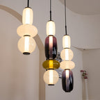 Coloured glass jar pendant lights glowing side by side