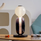 Crystal pebble table lamp shown lit on a black base