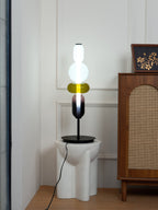Crystal cluster table lamp glowing on a black base