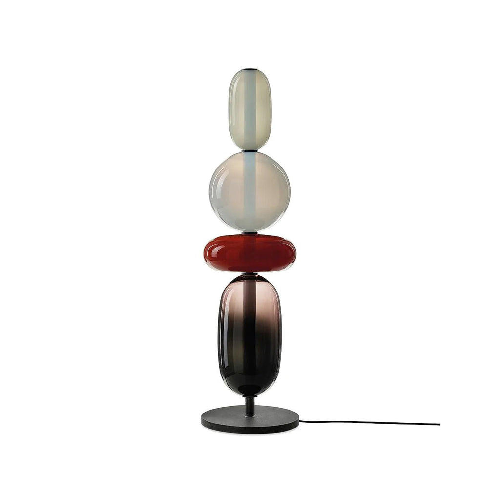 Green hand-blown crystal table lamp glowing in a dim room