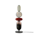 Green hand-blown crystal table lamp glowing in a dim room