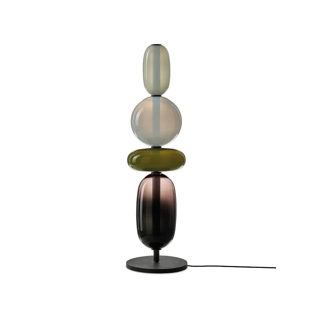 Crystal pebble table lamp casting soft light on a desk