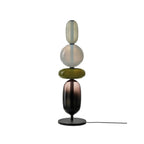 Crystal pebble table lamp casting soft light on a desk