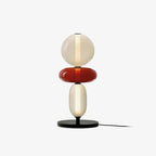 Crystal cluster table lamp with black base lit warmly