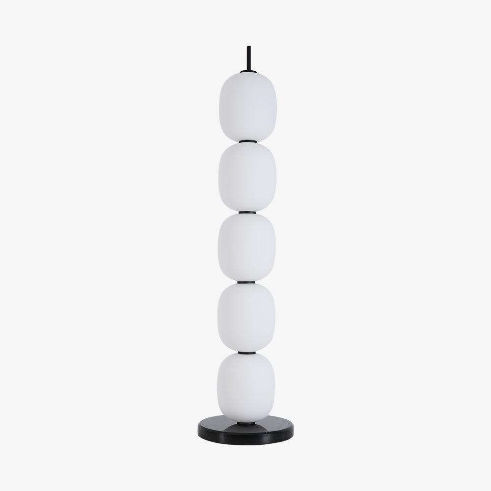 The unlit lamp straight on against plain pale grey, five globes above the marble disc.