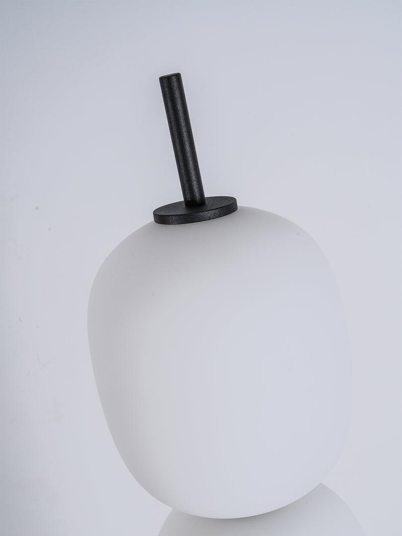Close view of the top globe and the short black stem that finishes the stack.