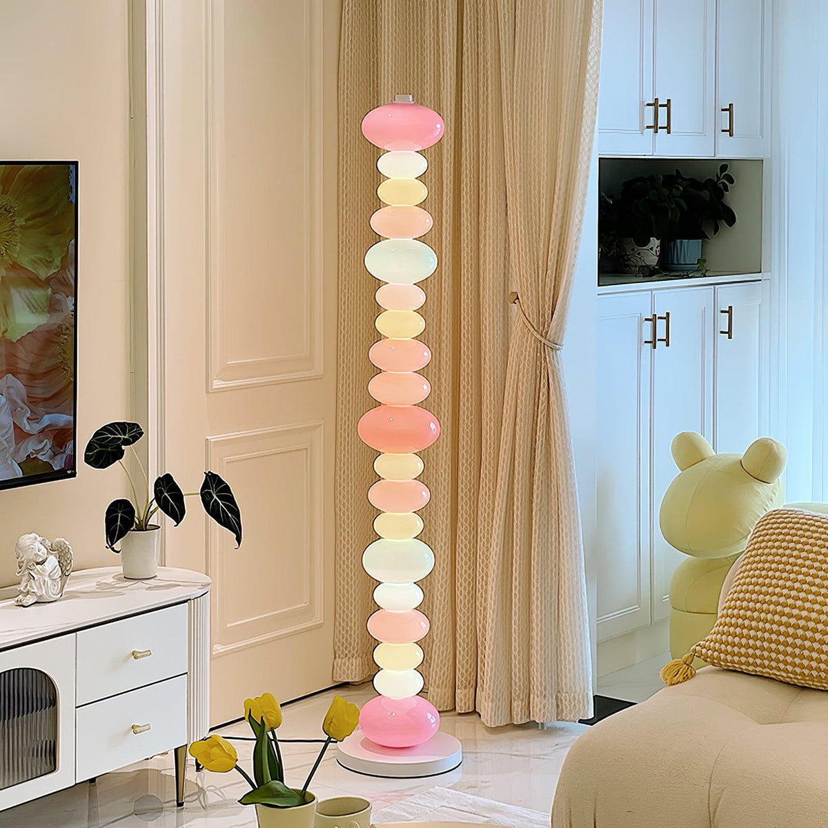 In a room with a potted plant and a yellow plush toy, this Clérachic floor lamp's pastel globes glow near a dresser.