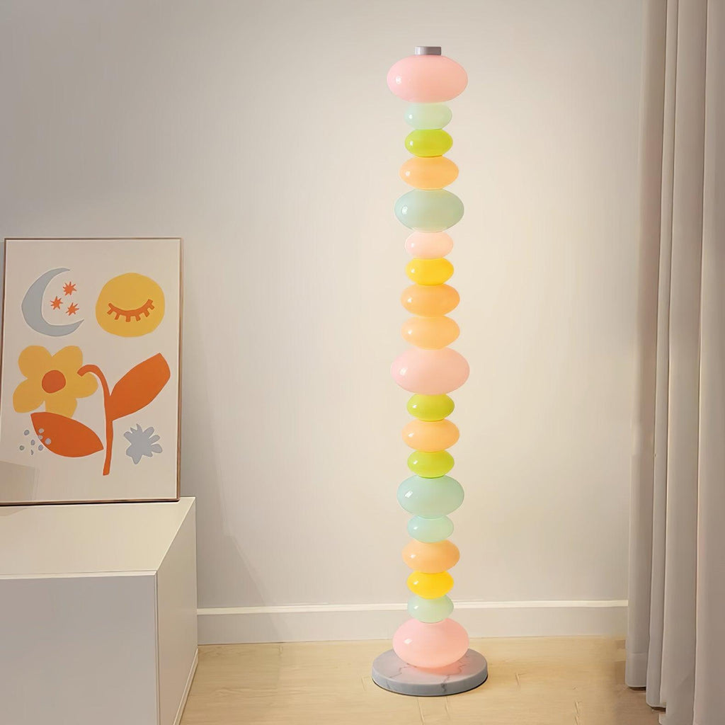 In a room corner beneath a moon and flower print, this Clérachic floor lamp's stacked globes stand beside a white cabinet.