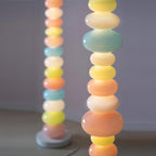 Photographed in close-up, the frosted glass globes of this Clérachic floor lamp show their soft colour gradient in detail.