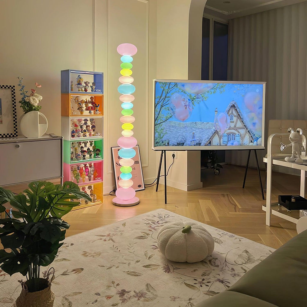 Near a toy display shelf and a pumpkin on the rug, this Clérachic floor lamp's globe column glows beside a television.