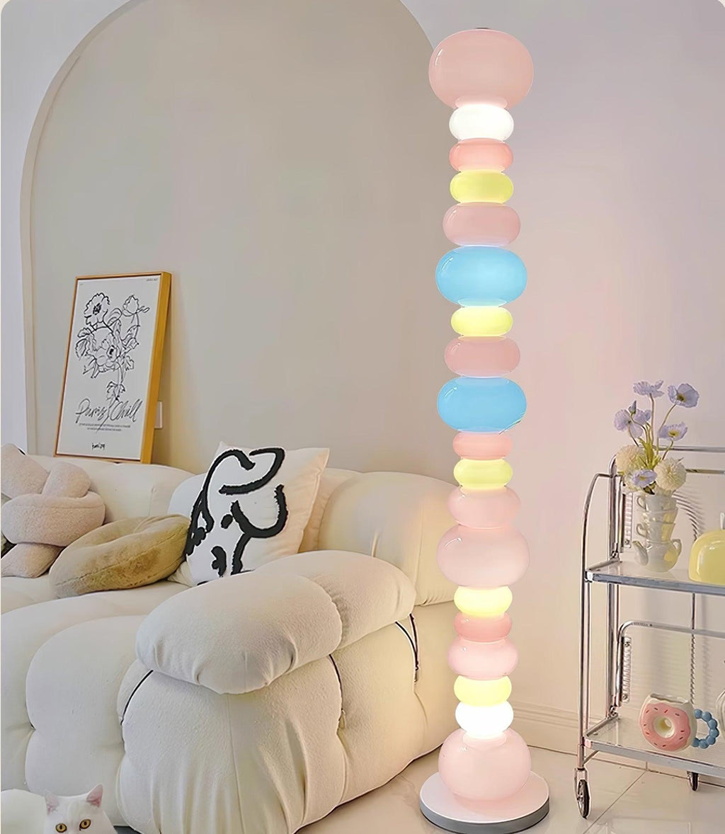 Next to a cream sofa with a resting cat and a bar cart, this Clérachic floor lamp's globe column glows warmly.