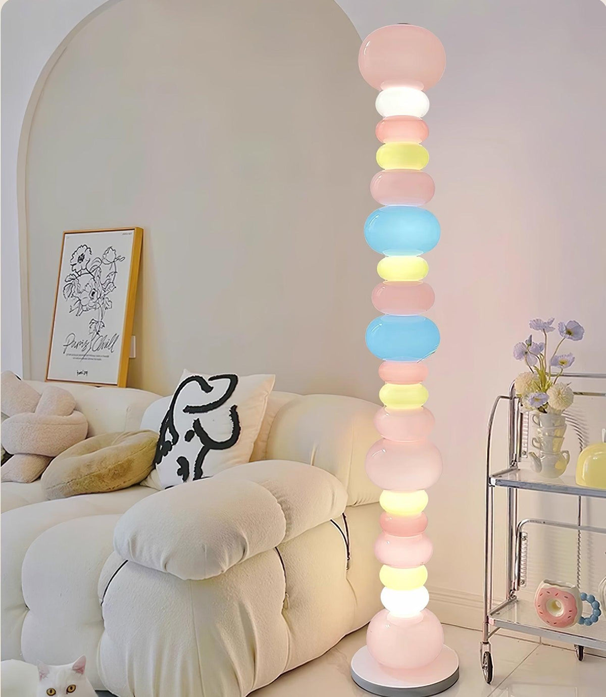 Next to a cream sofa with a resting cat and a bar cart, this Clérachic floor lamp's globe column glows warmly.