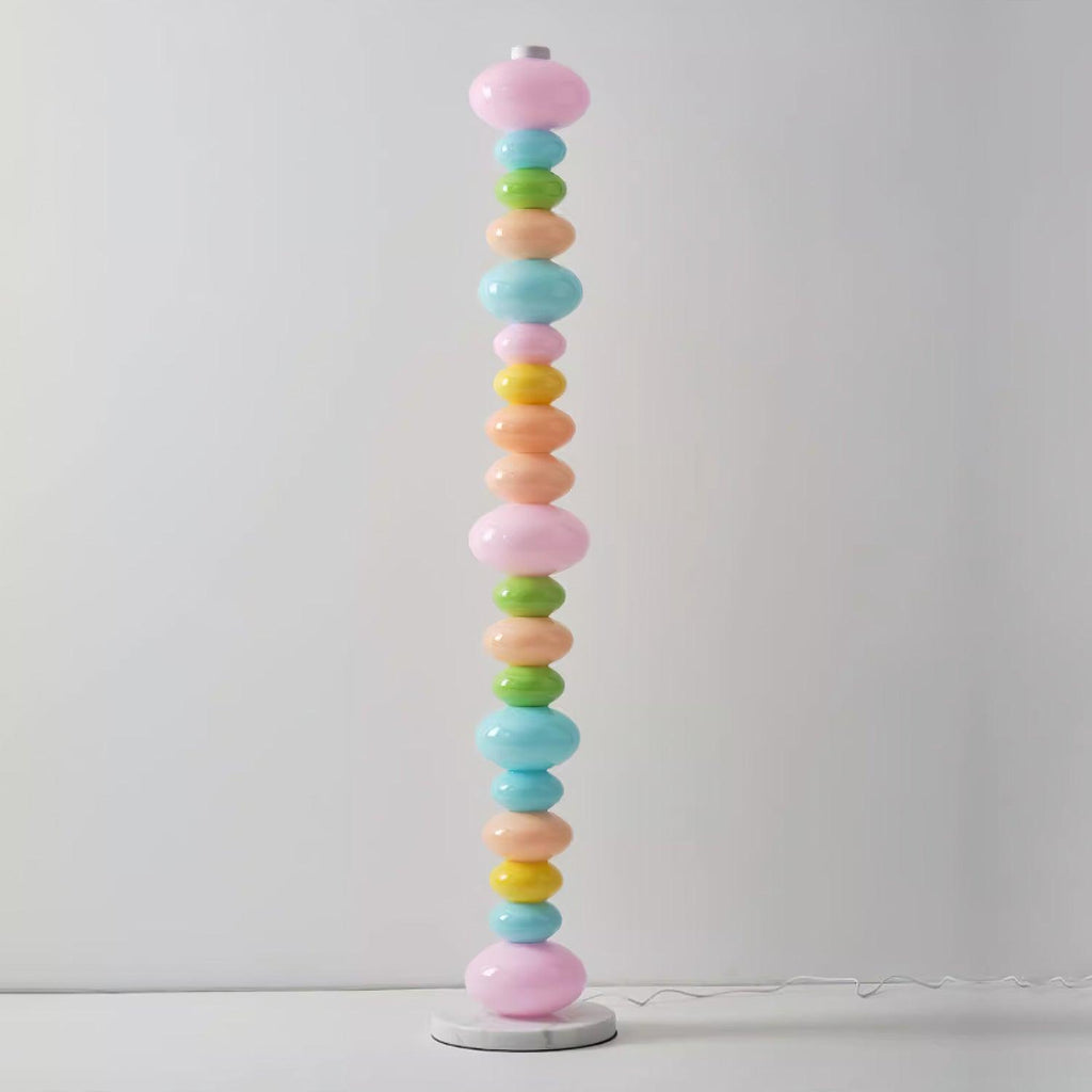 Standing alone on a pale studio backdrop, this Clérachic floor lamp shows its full column of glowing pastel glass globes.