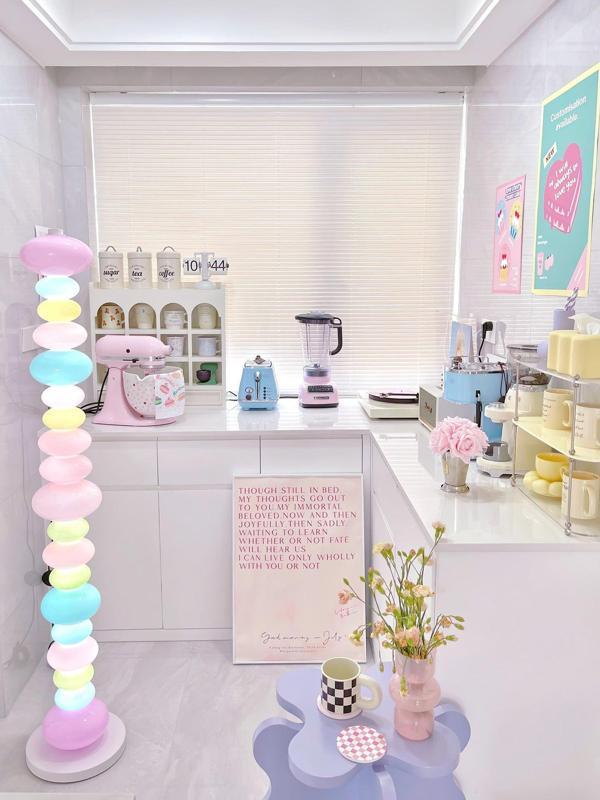 In a kitchen with a pink stand mixer and blue toaster, this Clérachic floor lamp's globe column glows near the window.