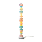 Standing alone against a plain white backdrop with its power cord visible, this Clérachic floor lamp glows fully lit.