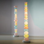 Two Clérachic glass globe floor lamps of different heights stand side by side, comparing the stacked-globe sizes.