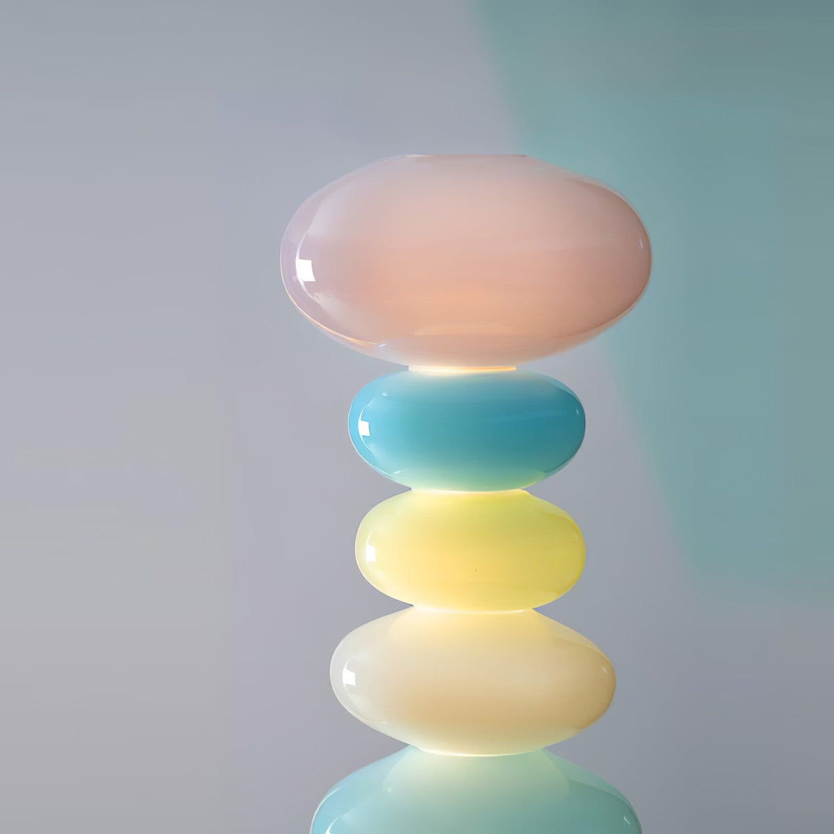 Extreme close-up of a Clérachic glass globe lamp's glossy top orbs against a plain grey background, showing the glass finish.
