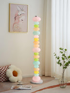 Clérachic stacked glass globe lamp glowing beside a framed rabbit print and a pink flower-shaped floor cushion.
