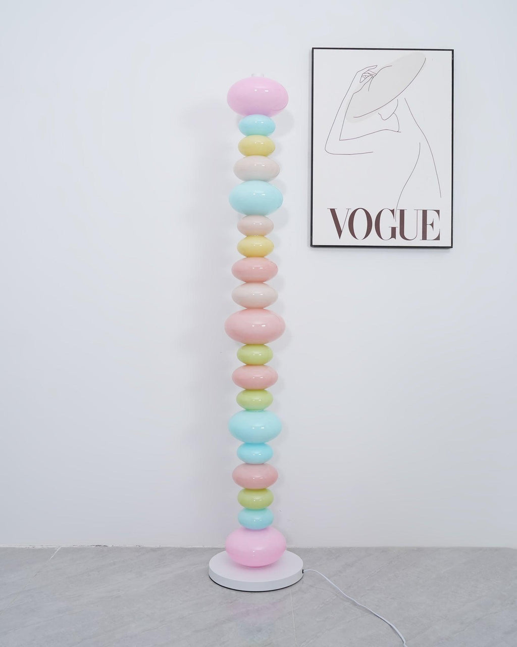Clérachic multicolour floor lamp shown unlit in a plain room, its pastel glass globes lit only by daylight.