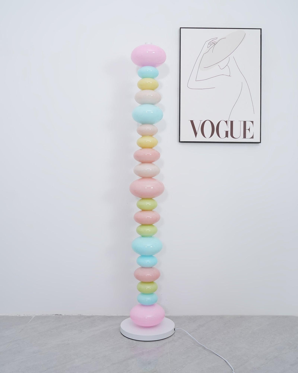 Clérachic multicolour floor lamp shown unlit in a plain room, its pastel glass globes lit only by daylight.