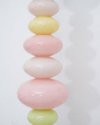 Photographed in close-up, the pastel glass globes of this Clérachic floor lamp show smooth colour blending from top to base.