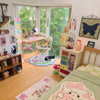 Clérachic pastel floor lamp lit in a child's bedroom, beside character-print rugs and a cat wall plaque.