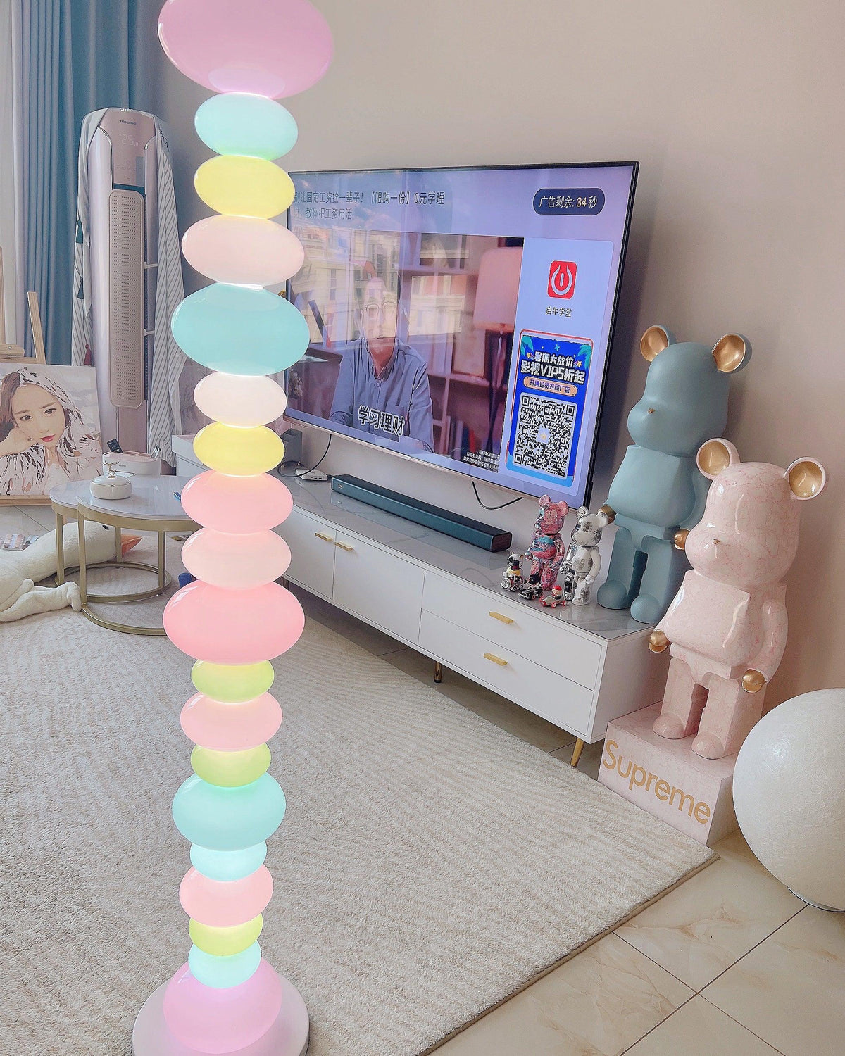 Clérachic stacked glass globe lamp lit beside a TV stand and oversized collectible bear figures on tiled floor.