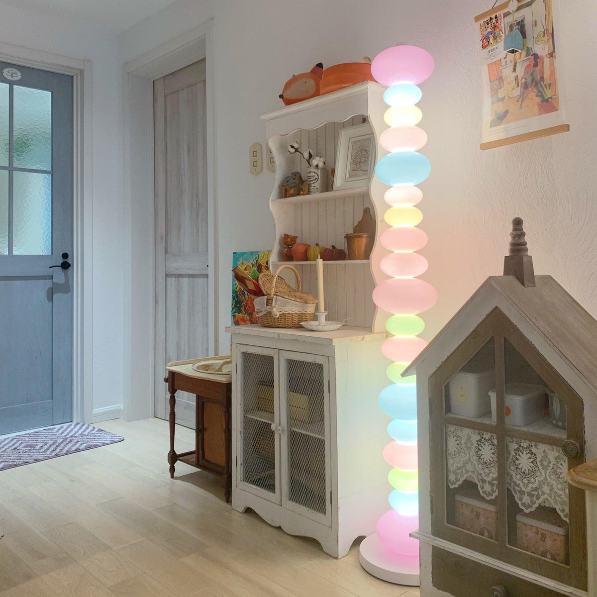 Clérachic stacked glass globe lamp lit beside a farmhouse-style cabinet, a dollhouse shelf and pumpkin decor.
