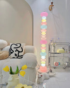 Clérachic glass globe lamp glowing beside a cream sofa and a glass bar cart topped with small bottles and vases.