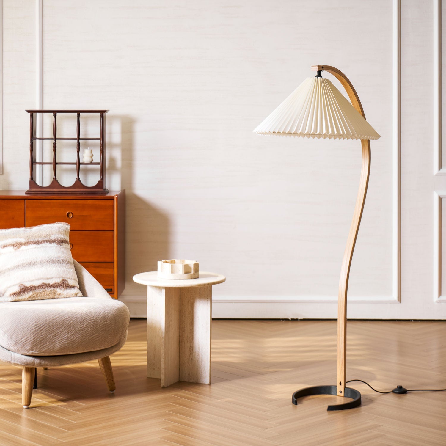 Floor lamp with iron base and linen drum shade in a living room