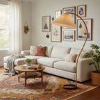 Caprani floor lamp standing tall with warm ambient lighting