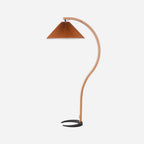 Caprani floor lamp shown beside a sofa with warm ambient glow