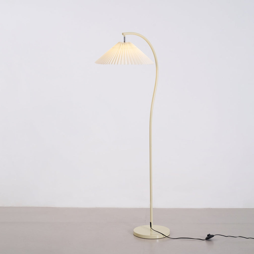 Pleated floor lamp adding soft light to a cosy corner